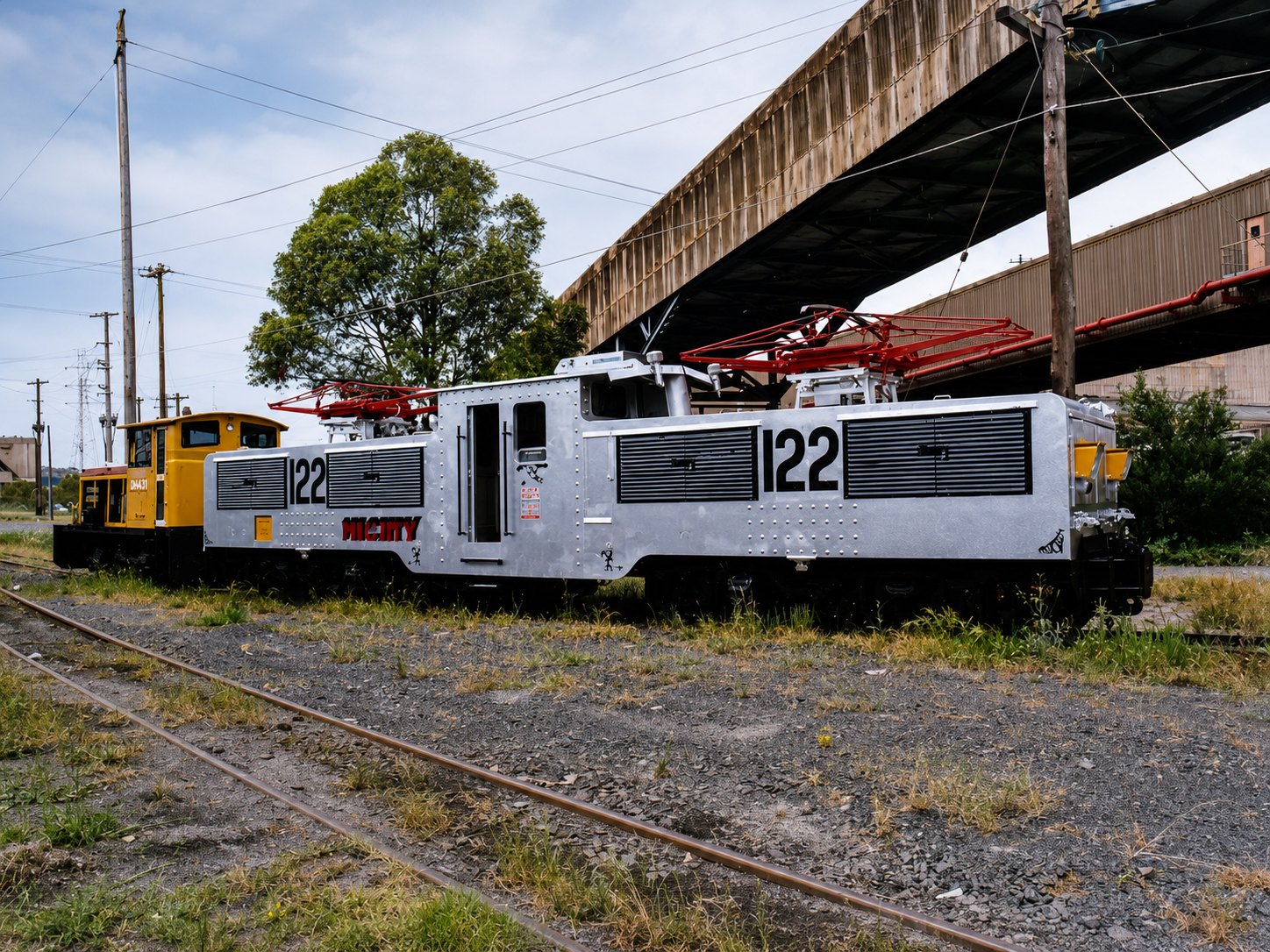 Restored historical photograph of Yallourn electric locomotive No. 122, Mighty Mouse, with blue shutters and pantographs.