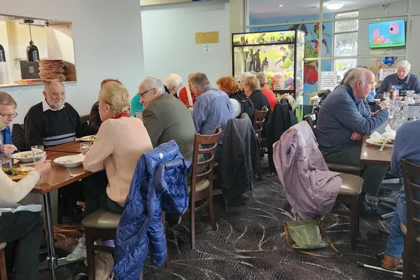 People sharing a meal at a group gathering