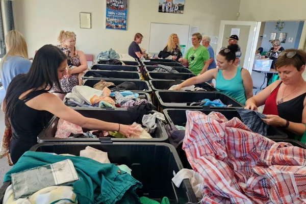 People sorting donated clothing at tables