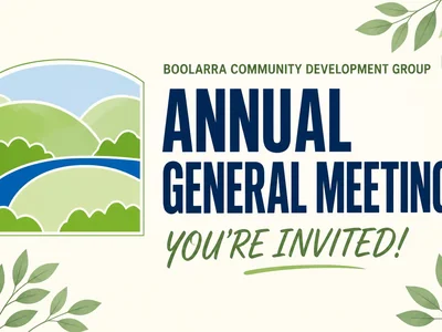 A community notice poster for the Boolarra Community Development Group Annual General Meeting, featuring the group's logo with green hills and a blue river.