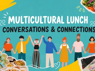 A diverse group of people of different backgrounds sharing food and conversation around a table at a multicultural community lunch.