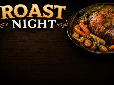 A golden-crusted roast surrounded by roasted carrots, potatoes and rosemary sprigs in a dark roasting pan.