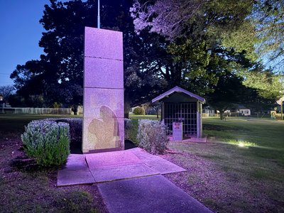 Members of the 2/29th Battalion AIF Association in uniform gathered at a town square memorial, Newborough Victoria.