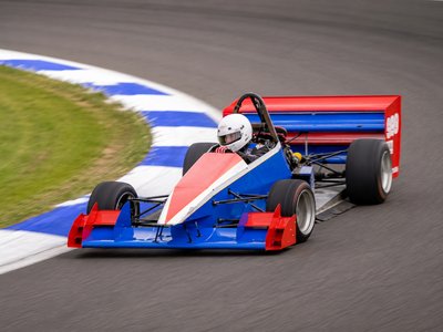 A racing car climbing the sealed hillclimb course at Bryant Park Gippsland Car Club in Yallourn, Victoria.