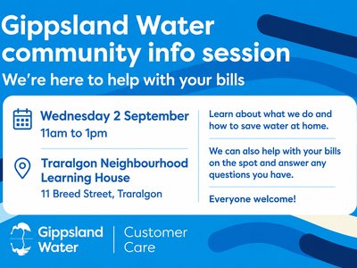 A Gippsland Water representative speaking with a community member at a neighbourhood house information table.