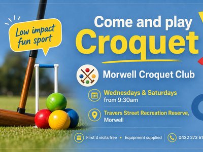 A croquet mallet resting beside colourful croquet balls on a green lawn, ready for play.