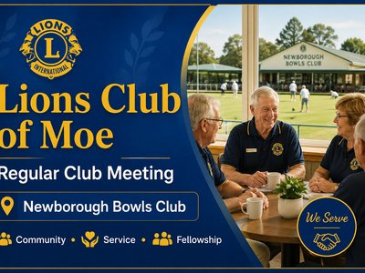 A group of Moe Lions Club members smiling together indoors at the Newbough Bowls Club.