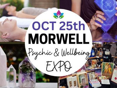 A colourful expo hall filled with stalls selling crystals, tarot cards and handcrafted goods, with visitors browsing and consulting practitioners.