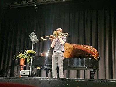 Young performers on stage at the Gippsland Performing Arts Centre during the Latrobe Valley Eisteddfod, with bright stage lighting and an audience in the background.