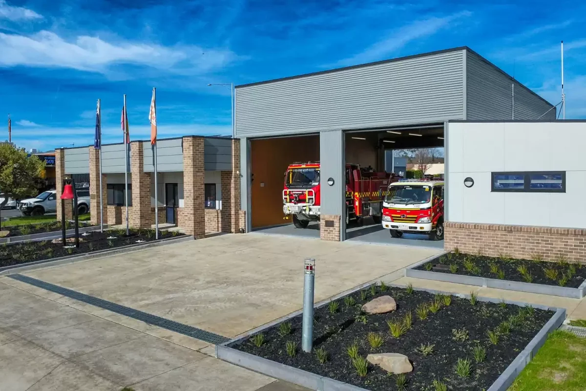 Moe Fire Station with two red fire appliances visible through the open motor-room doors.