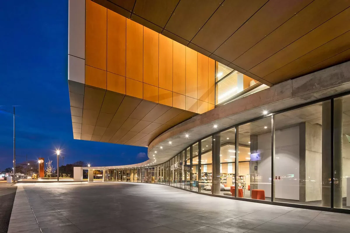 The Frank Bartlett Memorial Library's curved interior with bookshelves, reading tables and a timber ceiling.