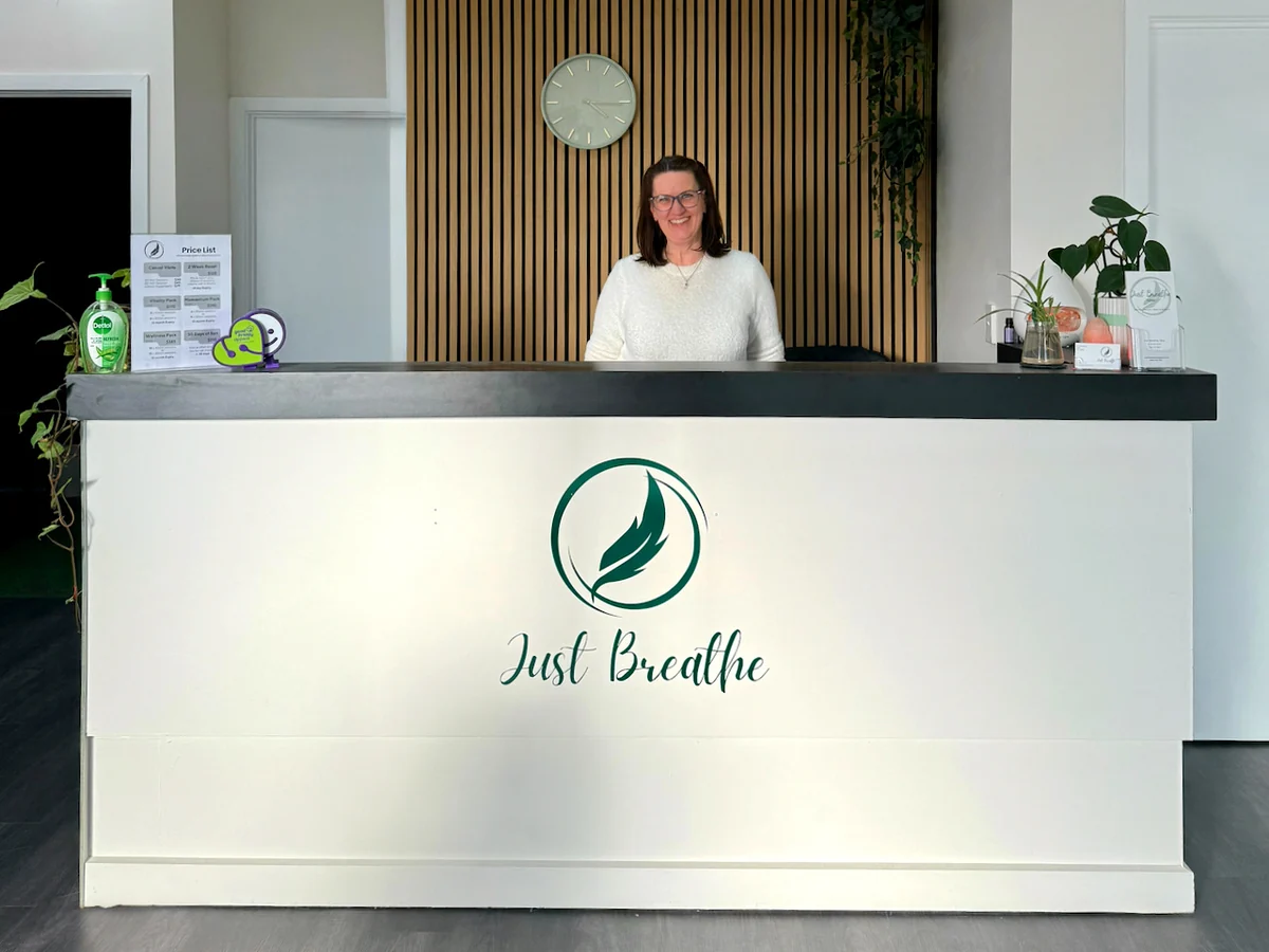 Wendy Stanway smiles behind the Just Breathe reception desk in Moe.