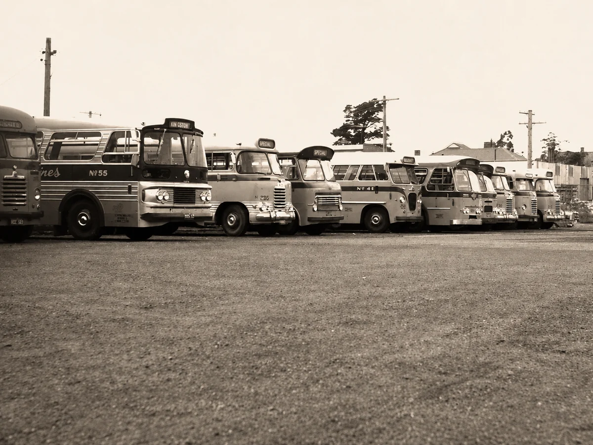 A historical lineup of buses parked side by side at a Latrobe Valley Bus Lines depot.