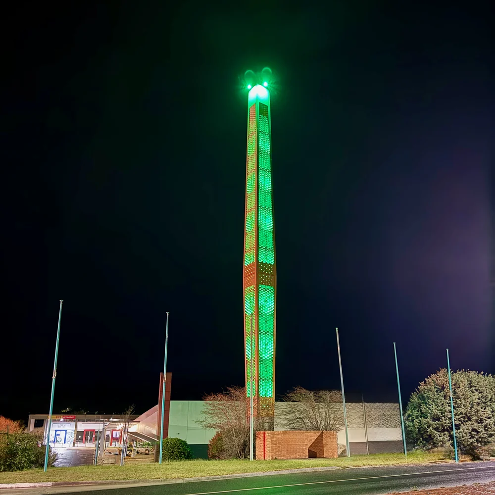 Churchill’s tall town symbol illuminated green against the night sky above the town centre.