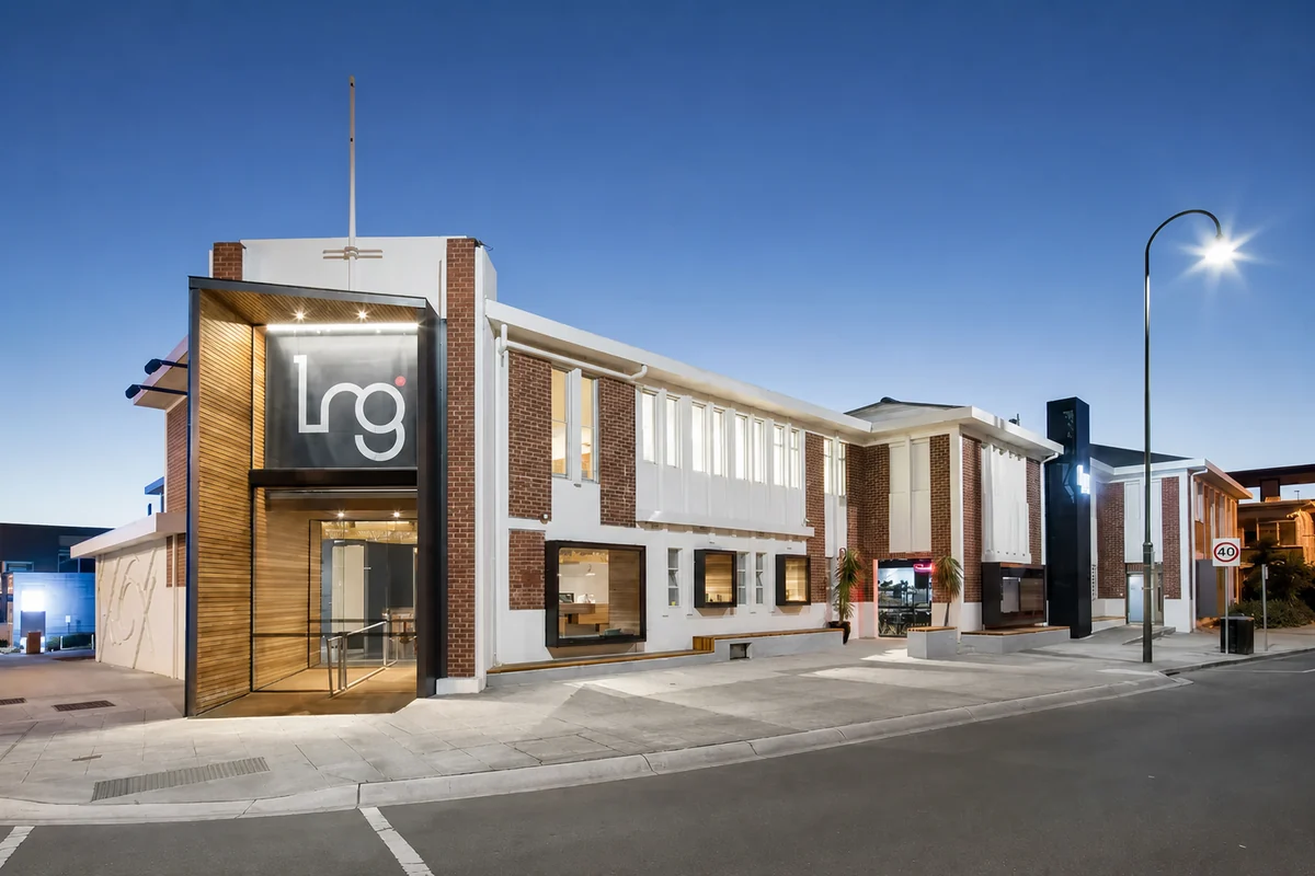 Latrobe Regional Gallery's brick and white facade illuminated at dusk.
