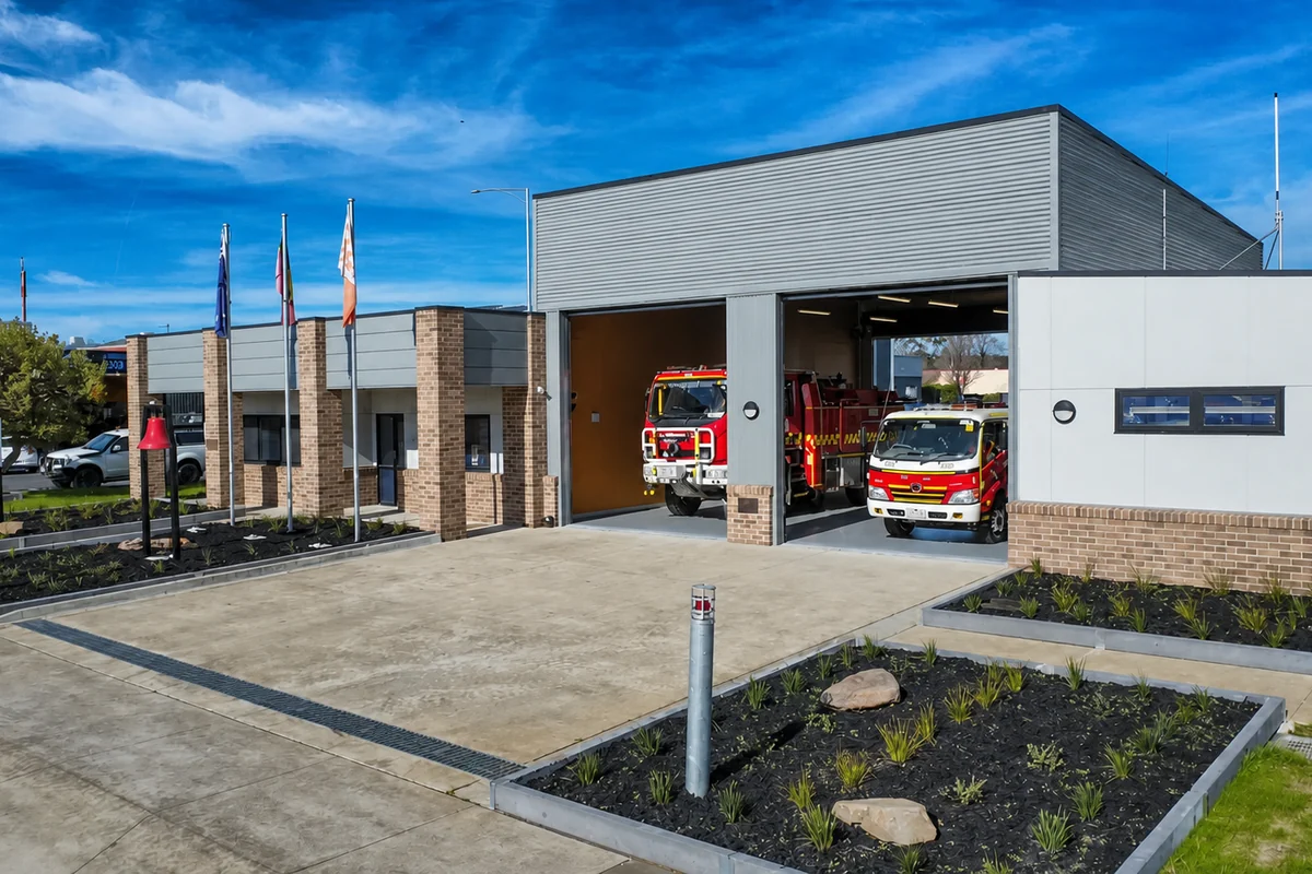 Moe Fire Station with two red emergency vehicles visible inside open appliance bays.