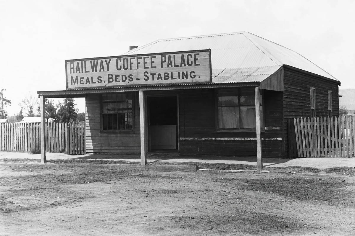 The timber Yinnar Railway Coffee Palace with a verandah and a sign advertising meals, beds and stabling.