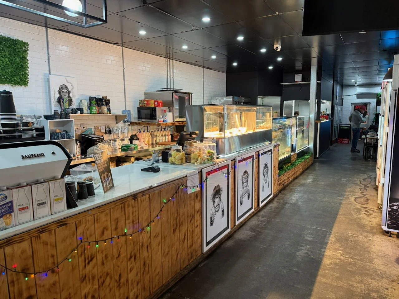 Coffee machine and food counter inside 38Forty Cafe, with seating towards the rear