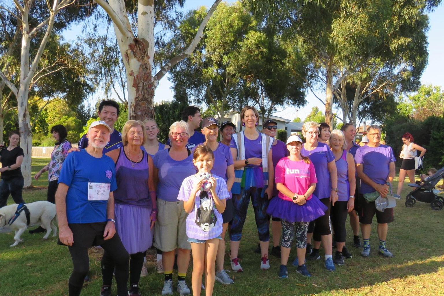 Traralgon parkrun participants gathered together beneath gum trees