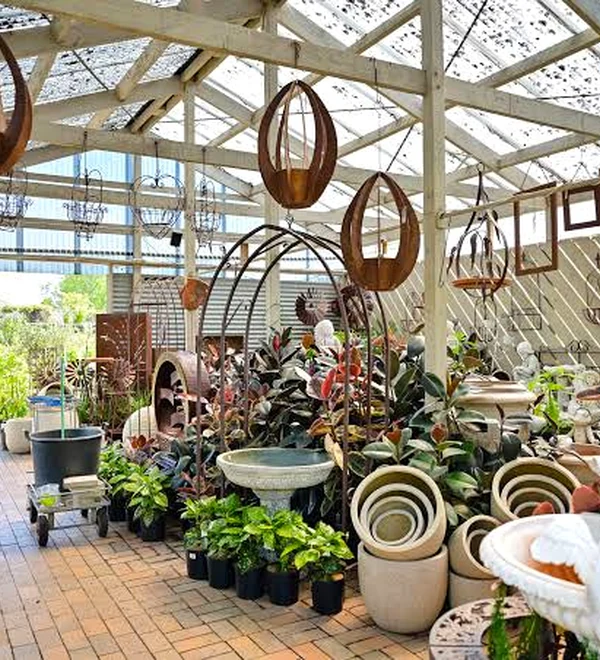 Plants, pots and garden ornaments arranged beneath a covered display area at Grow Master Traralgon.