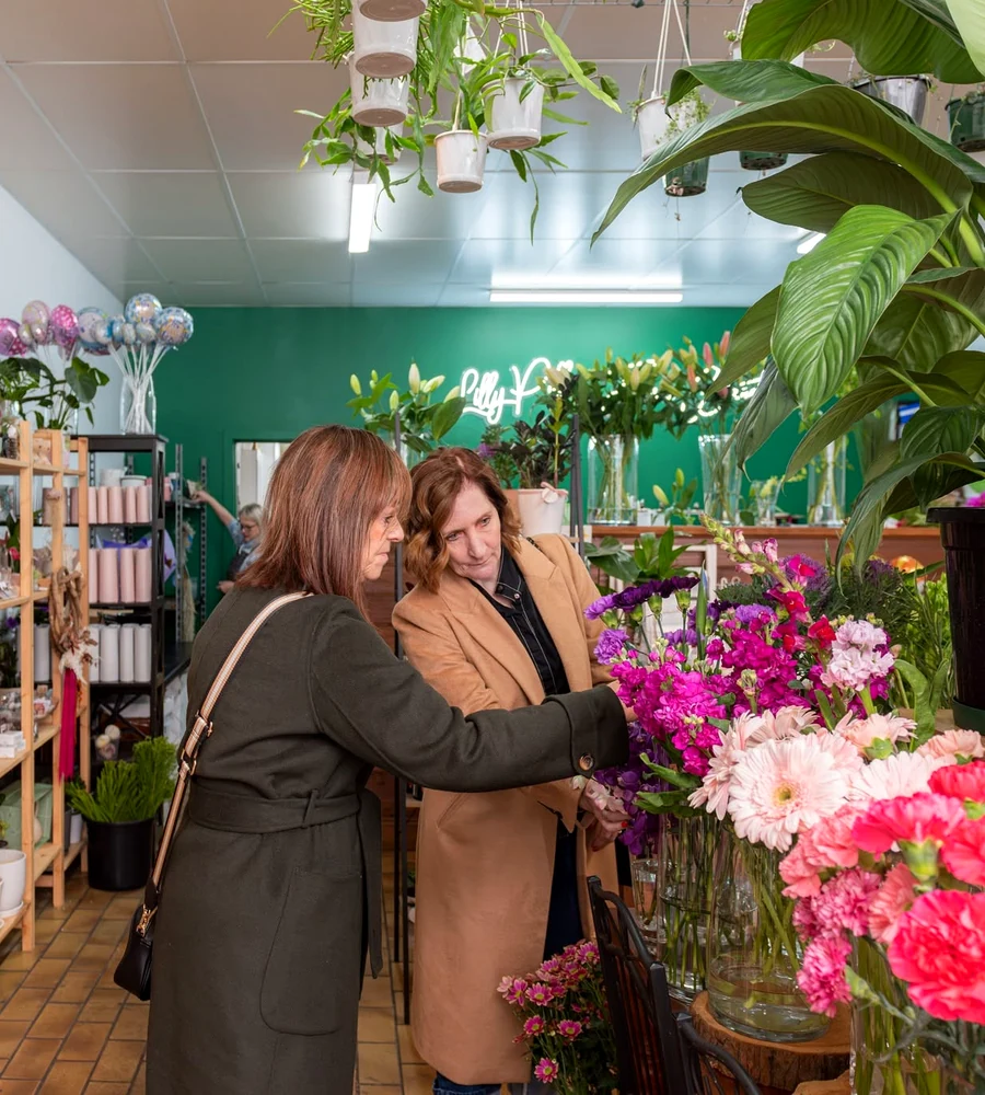 Two women selecting flowers inside Lilly Pilly Flower Boutique.