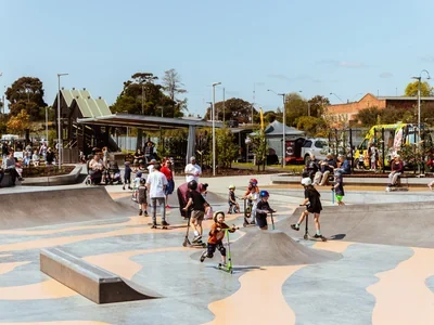 Skaters and scooter riders using the bowls and ramps at Moe Skate Park.