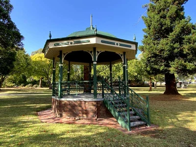 The historic rotunda stands among mature trees and lawns in Victory Park.