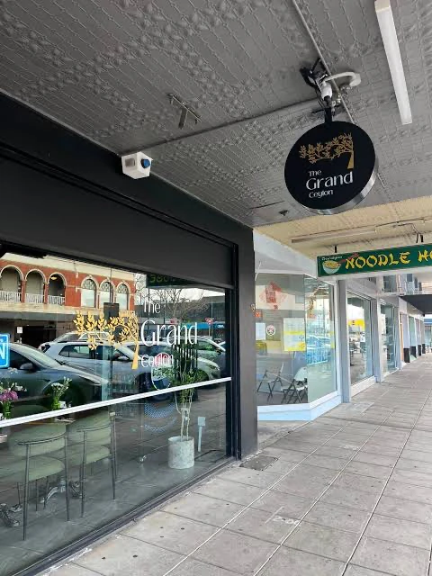 The Grand Ceylon shopfront and hanging sign beside the covered Franklin Street footpath.