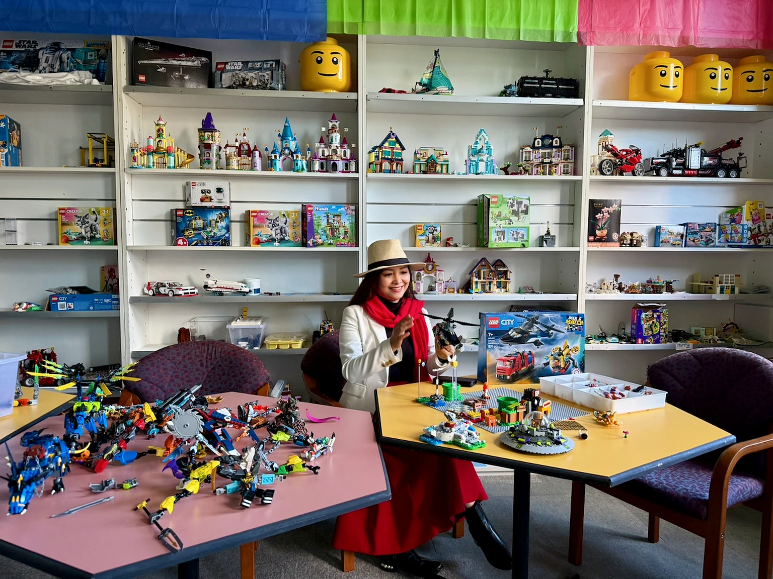 Visitor assembling a LEGO model at a table in the Production Centre.