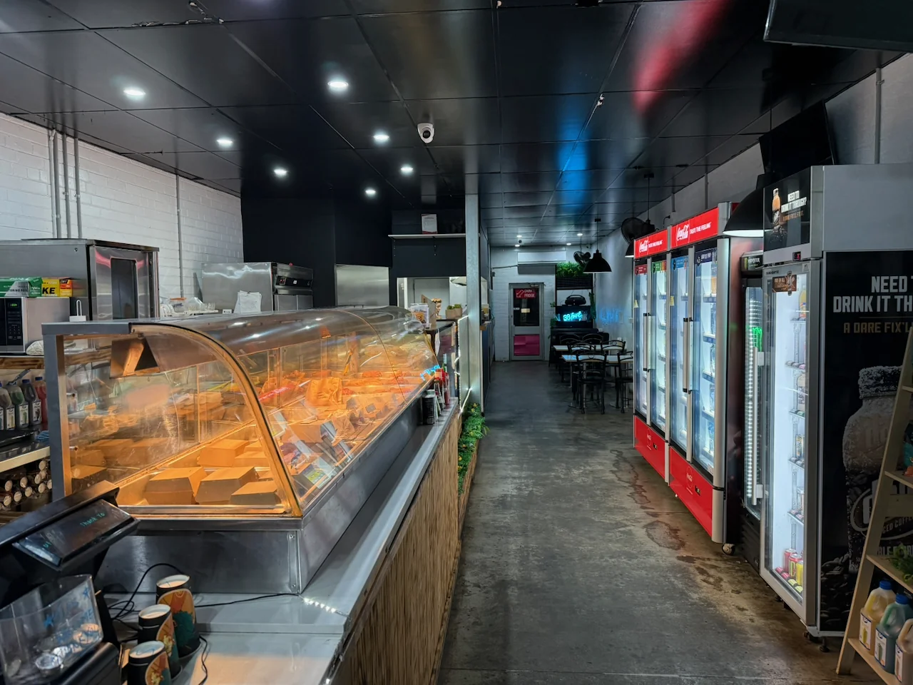 Food displays and drinks fridges along the cafe interior