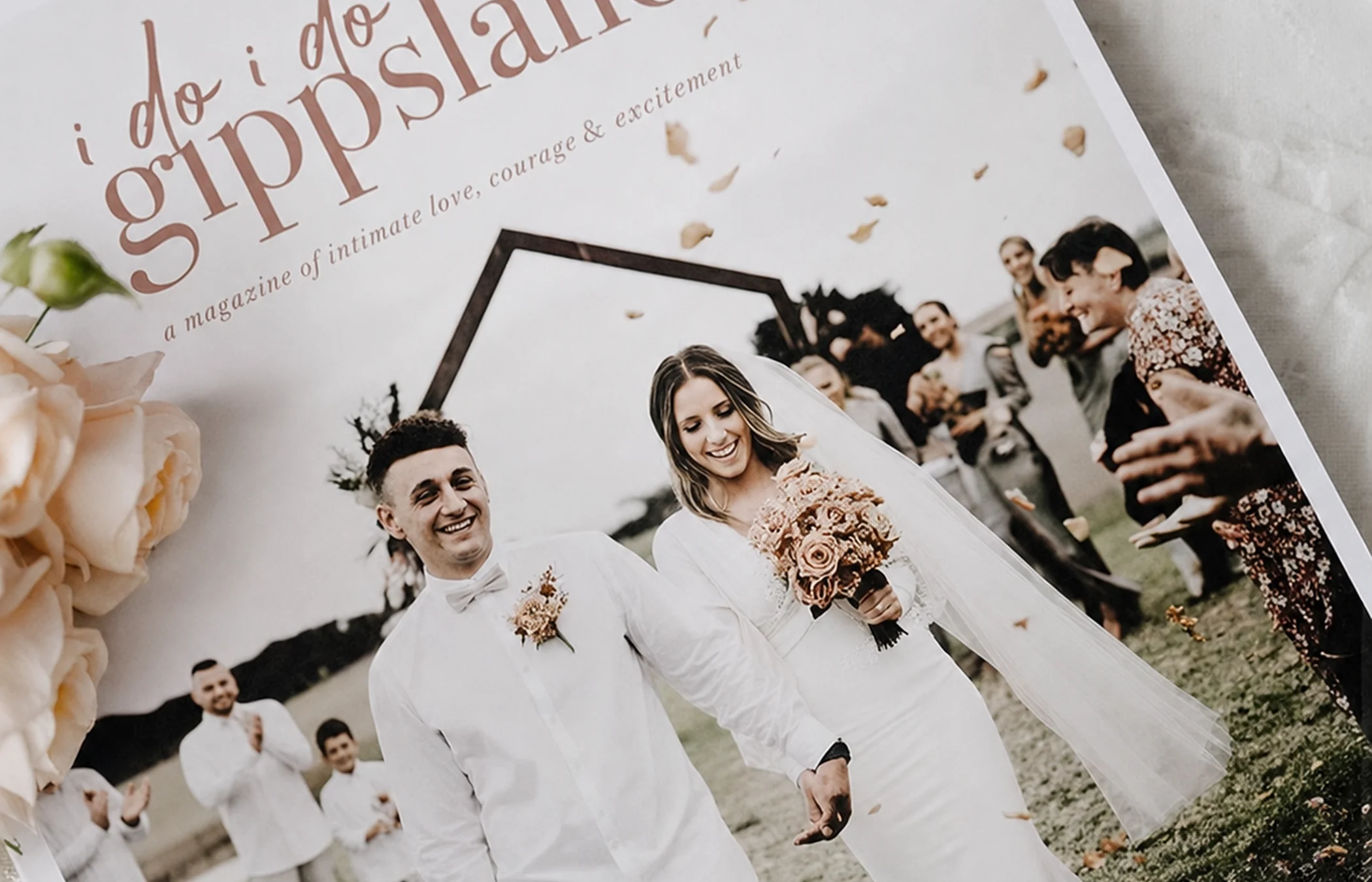 A copy of I Do I Do Gippsland magazine showing newlyweds walking hand in hand.
