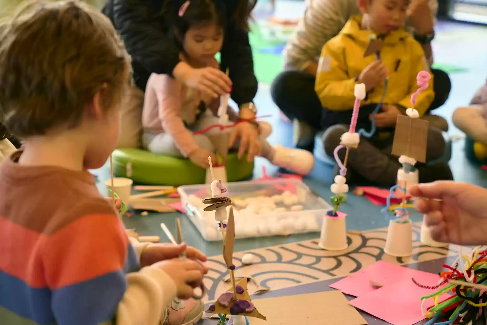 Children build colourful small sculptures from cardboard, pipe cleaners and soft craft materials at Morwell Library.