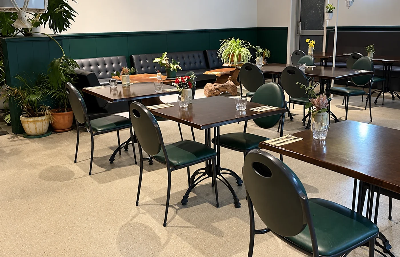 Timber tables and chairs in the covered seating area at Jay Dee's Cafe.