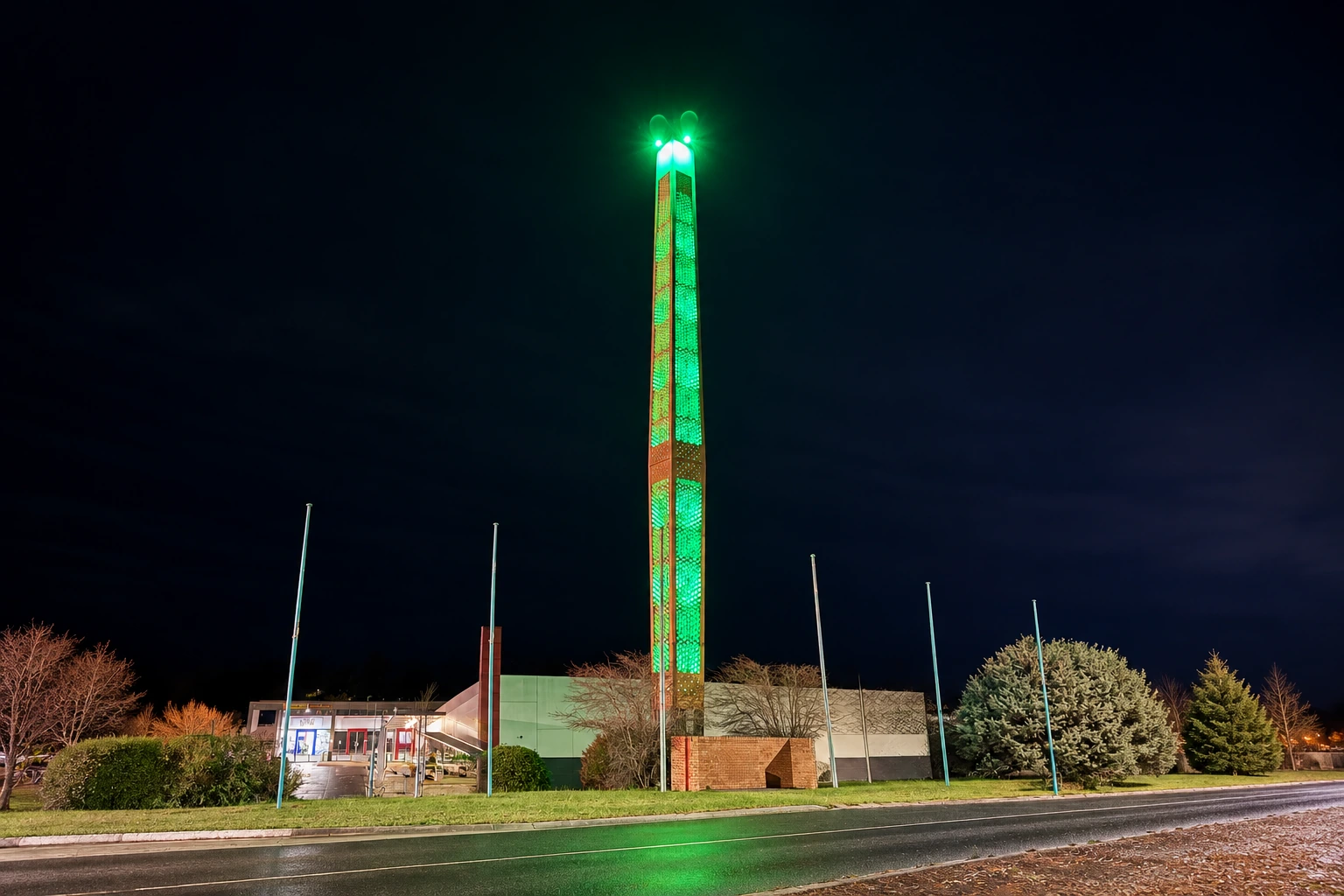 Churchill's illuminated town symbol glowing green above the town centre at night
