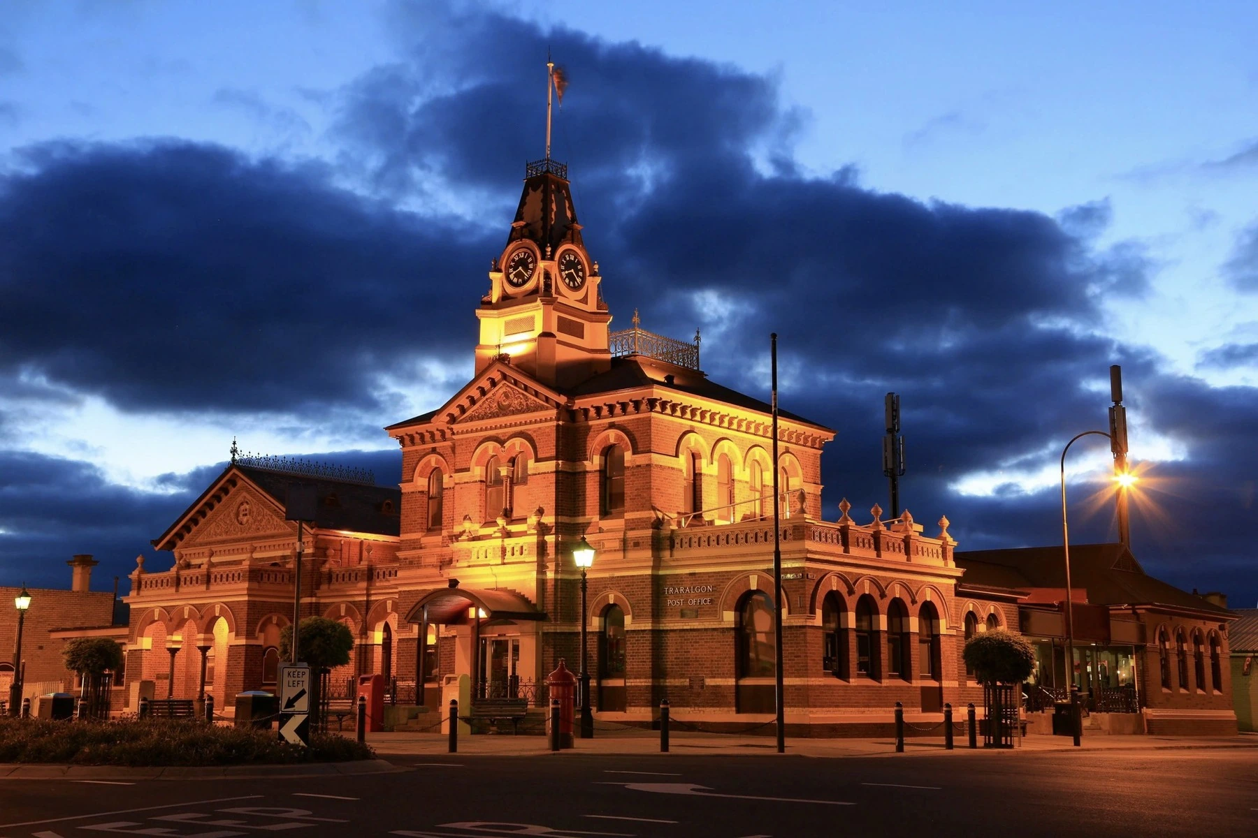 The illuminated Traralgon Post Office beneath a deep blue evening sky
